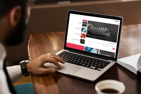 mockup-featuring-a-man-using-his-macbook-pro-on-a-wooden-desk-2321-el1